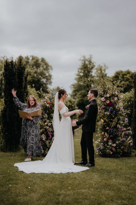 Sara Cumming - Celebrant, announcing a young couple who are holding hands, as Husband and Wife