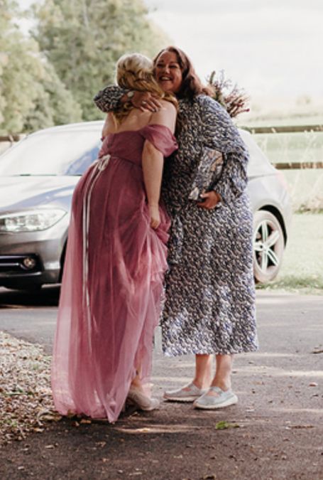 Sara Cumming - Celebrant, hugging a bride on arrival
