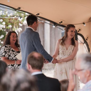 Bride and Groom laughing during a ceremony